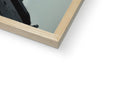 A large wooden photo frame holding many items in the mirror on a wall.