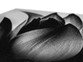 A black and white photograph of a rose on a white bedside table covered in tissue
