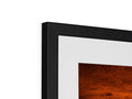 A photograph frames a picture frame on top of a television screen on a wall.