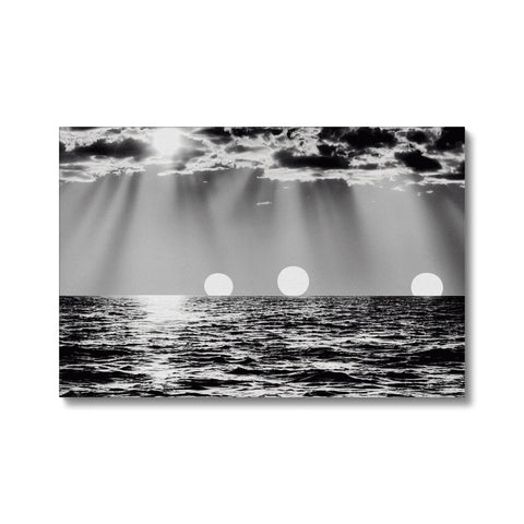A black and white print of a sunburst on a wall with a light blue water