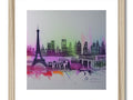 A silver framed art print of a city skyline behind a tall tower of the French city