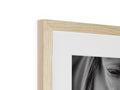 A piece of wood is used in a frame with a photograph in it.