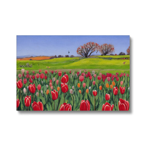 An art print showing tulips and white flowers in a field.