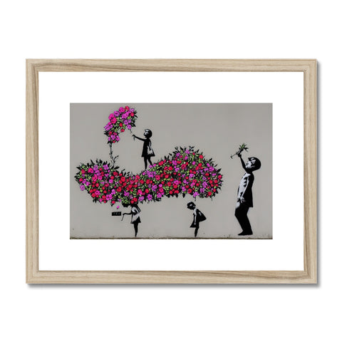 a piece of printed art on wall mounted with flowers