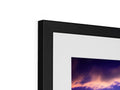 A picture frame with a photograph on it sitting on a black display device.