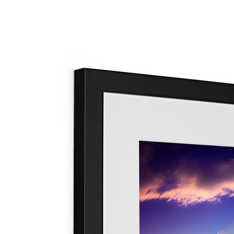 A picture frame with a photograph on it sitting on a black display device.