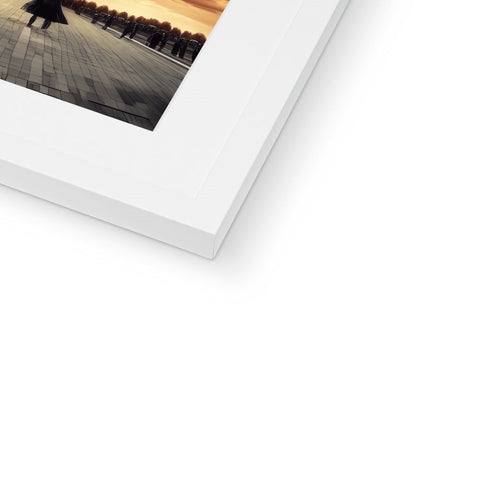 A small white picture on a white  photo frame with an object on it.