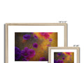 A framed photo of flowers with colorful colors on a white canvas