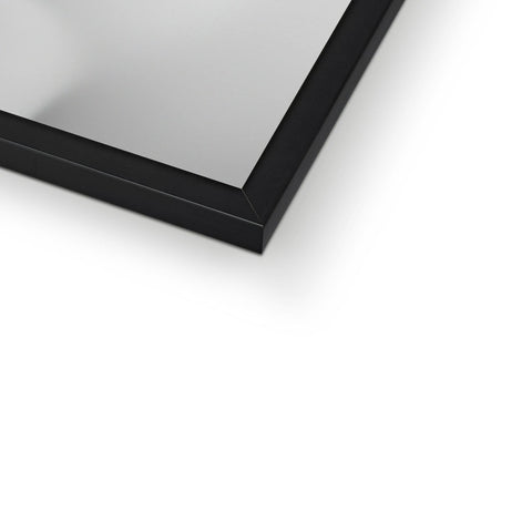 A close up image of a picture frame sitting on the mirror on top of a white