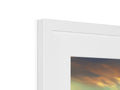A picture frame, framed in white with a picture of an imac on it sitting