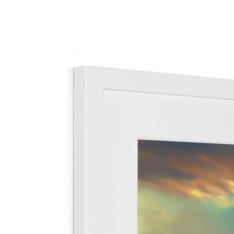 A picture frame, framed in white with a picture of an imac on it sitting
