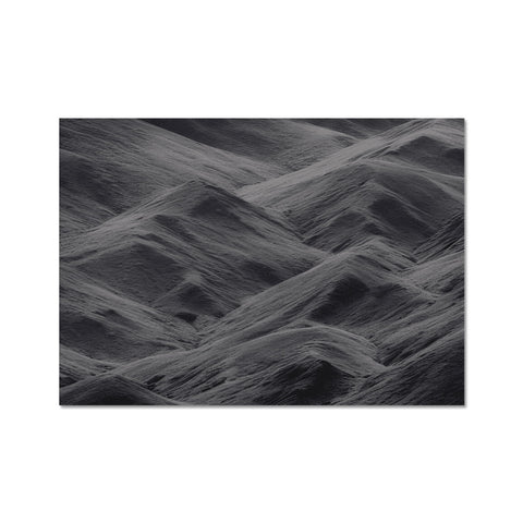 A piece of fabric on a dark black beach in an ocean next to water.