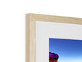 A white image in white wood with a blue background in a photo frame.