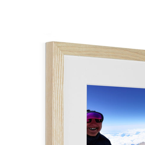 A white image in white wood with a blue background in a photo frame.