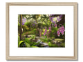 A white photo in a photo frame of tropical plants with purple orchids in it