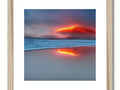 A large photo of an old volcano on a wooden frame framed with a red light and