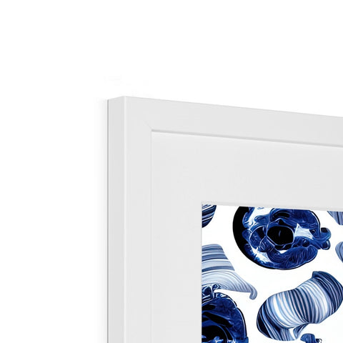 A white picture frame with artwork on it hanging on a wall.