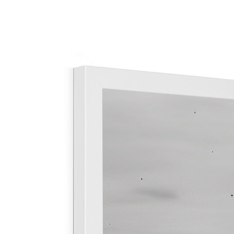 A flat panel clock sitting on the side of a white wall.