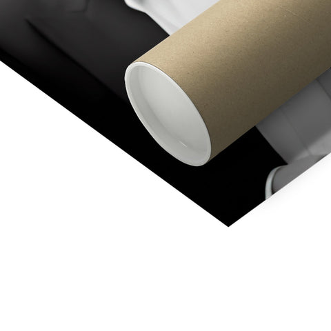 A toilet roll containing a roll of toilet paper sitting on a black and white table.