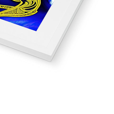 A picture of an abstract image sitting on a shelf topped in gold with a blue picture
