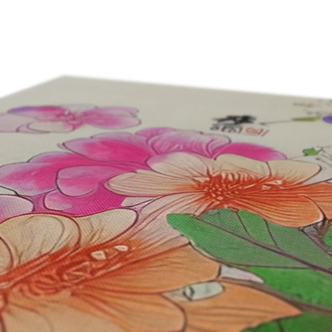 A table top with a floral printed painting, flowers and a pencil.