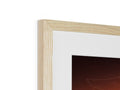 A framed picture of wood frames standing in a wood fireplace.
