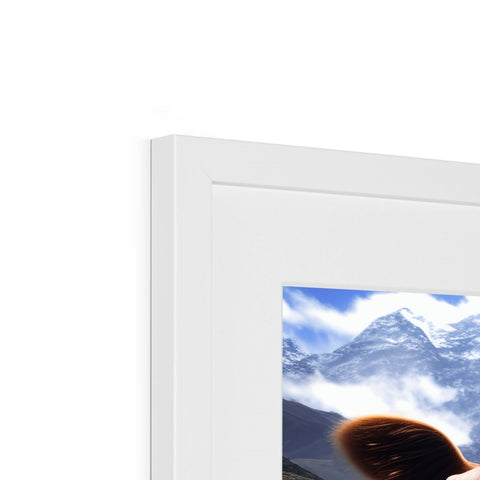 A picture frame with a window sill next to an imac with a small picture on