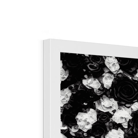 A picture frame covered with a white picture of roses on a black background.
