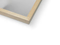 a mirror shows pictures of wood frames on a white background