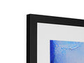 A framed photo of an abstract painting in blue framing.