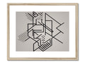 A framed art print with black and yellow geometric design sitting on a counter.