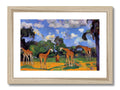 A group of giraffes looking out into a lush green bush with trees in the