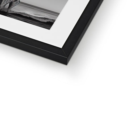 A picture frame with a white photo on it with a small child laying on top of