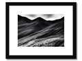 Black and white pictures of mountains in a desert surrounded by desert