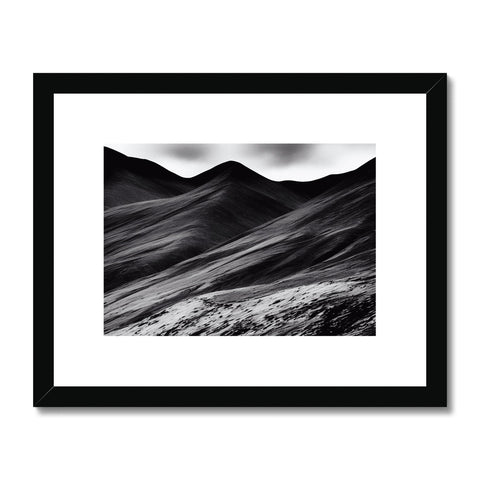 Black and white pictures of mountains in a desert surrounded by desert