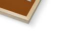 A brown and white photo of a book laying on a white piece of wood.