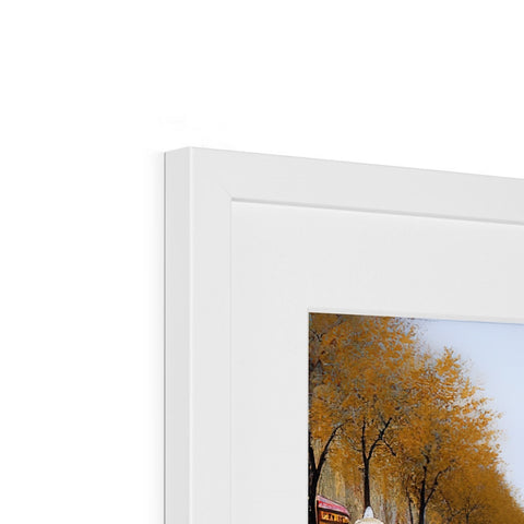 A picture frame with a white and blue picture in view of a tree.