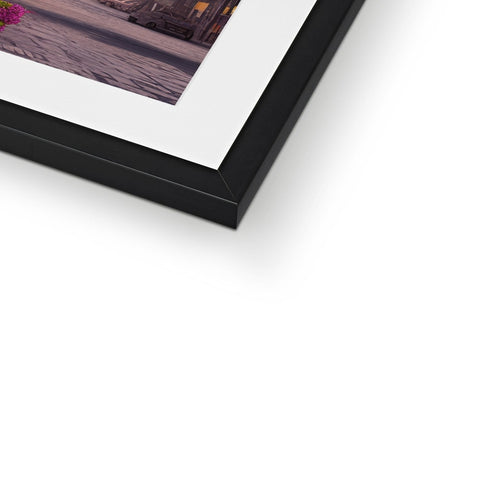 A white photo hanging on a picture frame top of a table.