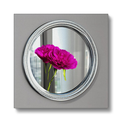 A colorful mirror sitting on top of a photo frame next to a wall mounted photo.