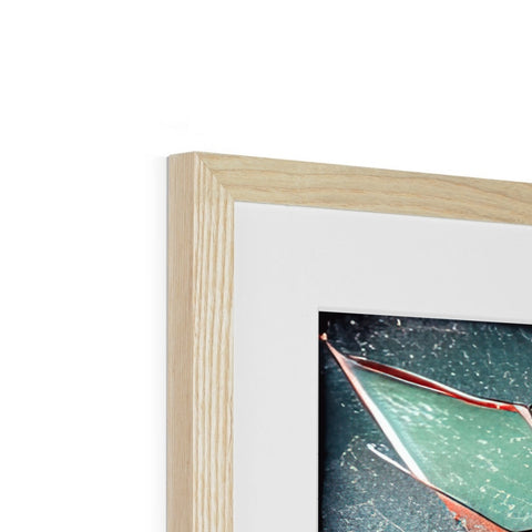 A piece of wood is placed in a white framed picture frame on a wall.