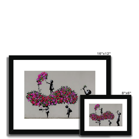 a black and white framed picture of a pink and white tree with a lot of flowers