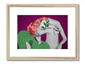 An art print of two woman hugging each other next to flowers on a pillow.