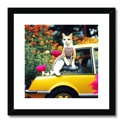 a cat is sitting on top of a photograph in a white frame on a table by