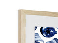 A photo of a blue picture on a wooden card in a framed frame.