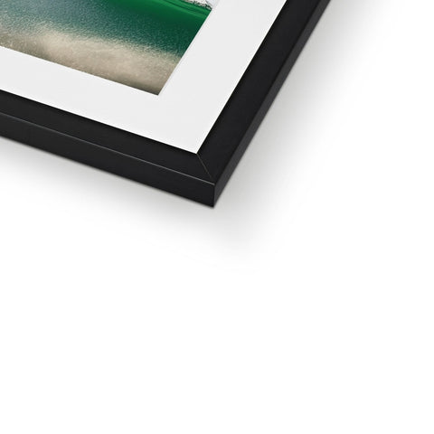 A picture of a green bird on a white picture frame.