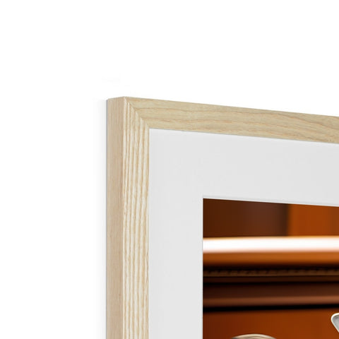 A wooden picture frame that is leaning against one wall behind a mirror.