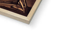 A softcover book on a book shelf that has a photograph with a wooden frame on
