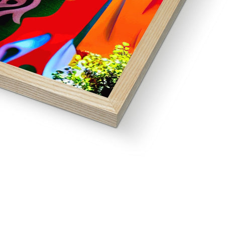 An art print sitting on top of a wooden frame with a flower on it.