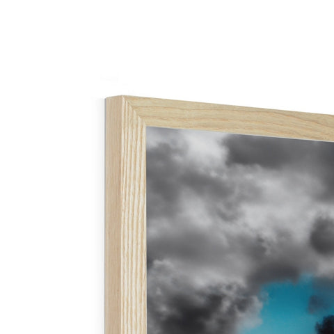 Wooden picture frame with a picture of a sky and a cloud placed on it