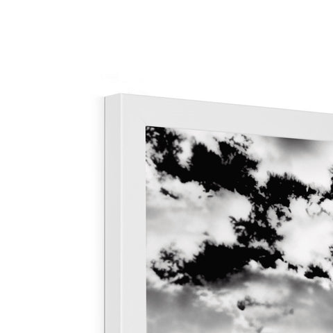 An image of cloud that hangs in a picture frame with several black and white pictures.